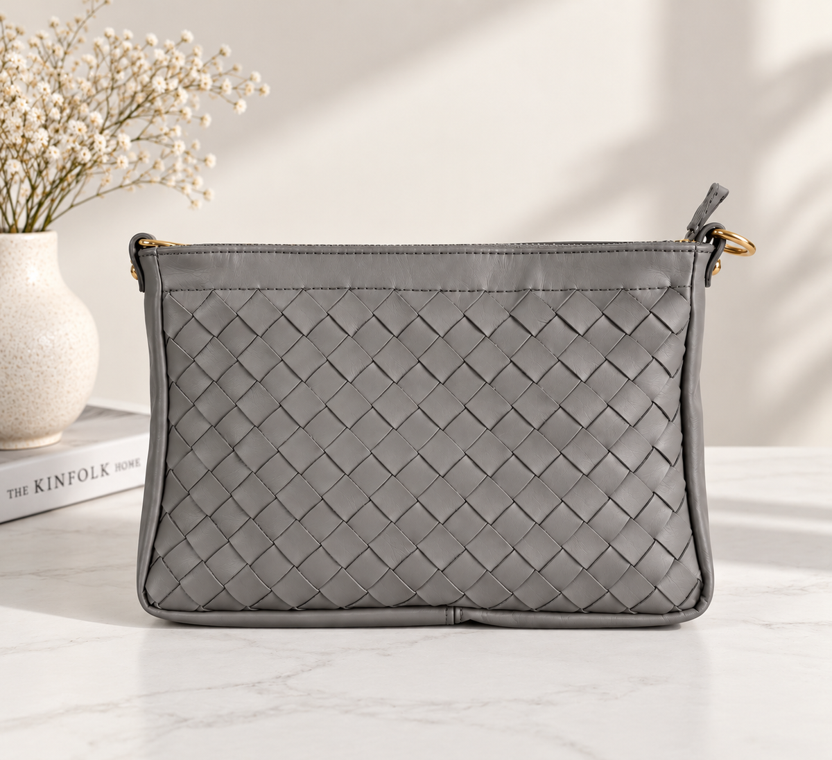 CLUTCH INTRECCIATA IN VERA PELLE